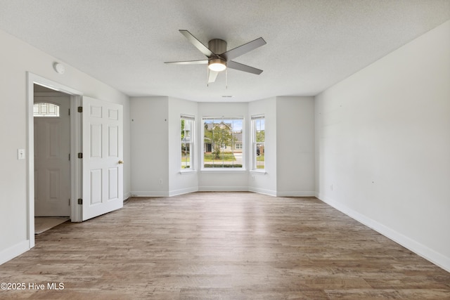 1415 Setter Ct, Wilmington, NC 28411 - empty room featuring a ceiling fan, wood finished floors, a textured ceiling, and baseboards