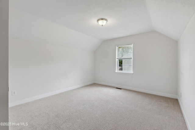 1415 Setter Ct, Wilmington, NC 28411 - additional living space featuring vaulted ceiling, carpet, and baseboards