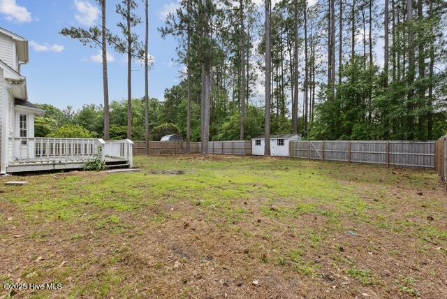 1415 Setter Ct, Wilmington, NC 28411 - view of yard featuring a deck and view of wooded area