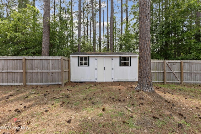 1415 Setter Ct, Wilmington, NC 28411 - view of shed with a fenced backyard and view of wooded area