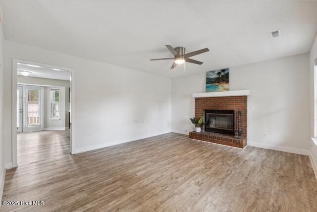1415 Setter Ct, Wilmington, NC 28411 - unfurnished living room featuring a ceiling fan, wood finished floors, a fireplace, and baseboards