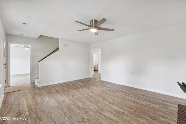 1415 Setter Ct, Wilmington, NC 28411 - unfurnished living room featuring ceiling fan, wood finished floors, baseboards, and stairway