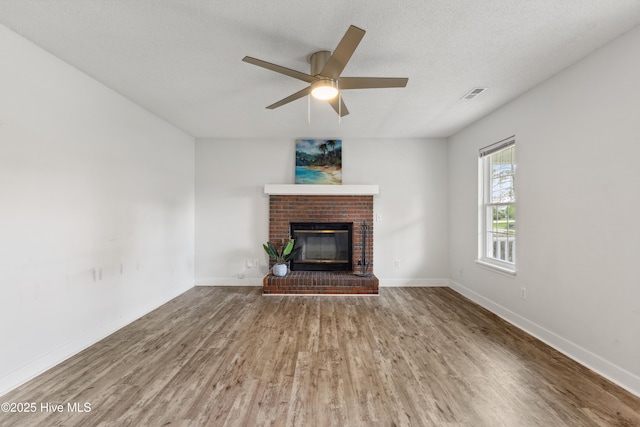 1415 Setter Ct, Wilmington, NC 28411 - unfurnished living room featuring wood finished floors, a fireplace, a ceiling fan, and baseboards