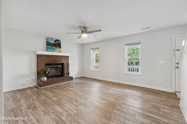 1415 Setter Ct, Wilmington, NC 28411 - unfurnished living room with ceiling fan, wood finished floors, a brick fireplace, and baseboards