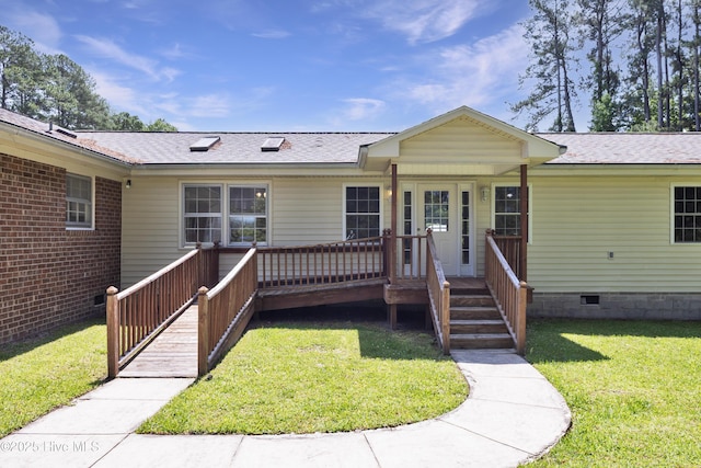 view of front of property with a front yard, roof with shingles, a wooden deck, and crawl space