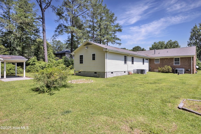 back of house with crawl space, central AC unit, and a yard