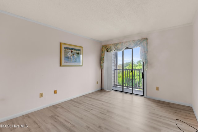 2306 W Fort Macon Rd Unit 209H, Atlantic Beach, NC 28512 - unfurnished room featuring wood finished floors, crown molding, baseboards, and a textured ceiling