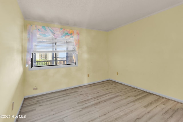 2306 W Fort Macon Rd Unit 209H, Atlantic Beach, NC 28512 - spare room with wood finished floors, ornamental molding, and baseboards