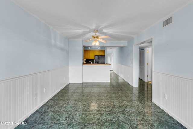 2306 W Fort Macon Rd Unit 209H, Atlantic Beach, NC 28512 - unfurnished living room featuring a wainscoted wall and ceiling fan