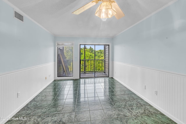 2306 W Fort Macon Rd Unit 209H, Atlantic Beach, NC 28512 - spare room with wainscoting, crown molding, and ceiling fan