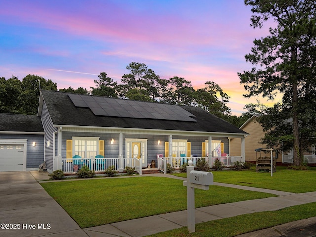211 Brook Crossing Rd, Swansboro, NC 28584 - view of front of house featuring a porch, solar panels, a yard, and concrete driveway