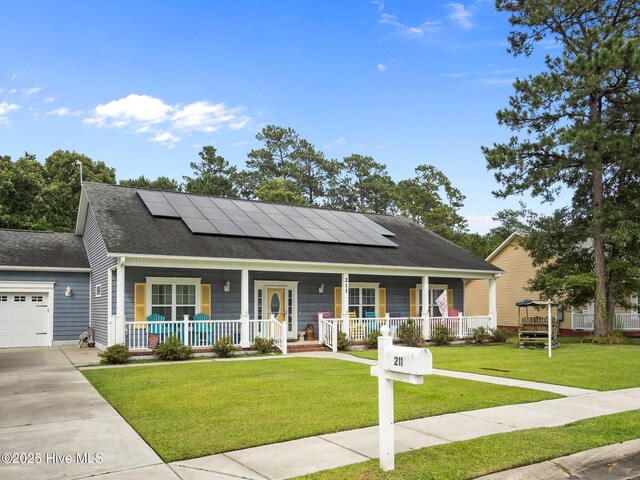 211 Brook Crossing Rd, Swansboro, NC 28584 - view of front of home with covered porch, roof mounted solar panels, a shingled roof, and a garage