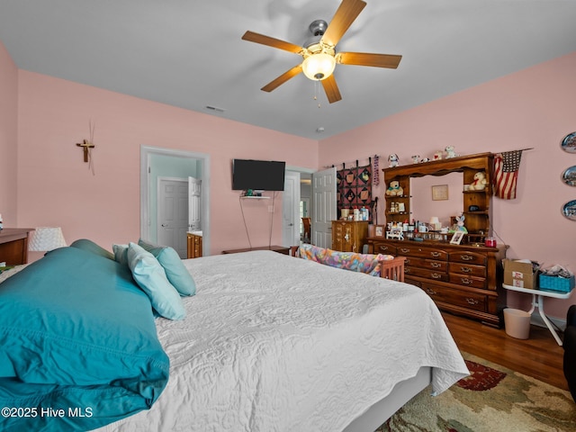 211 Brook Crossing Rd, Swansboro, NC 28584 - bedroom with wood finished floors, a ceiling fan, and ensuite bathroom