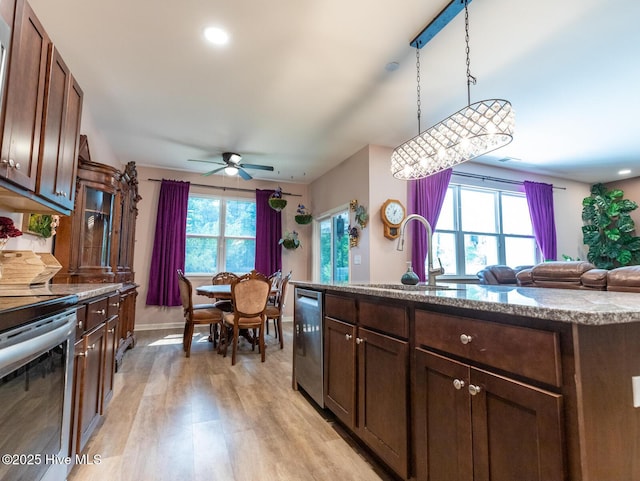 227 Cheswick Dr, Holly Ridge, NC 28445 - kitchen featuring appliances with stainless steel finishes, light wood-type flooring, a ceiling fan, pendant lighting, and a sink