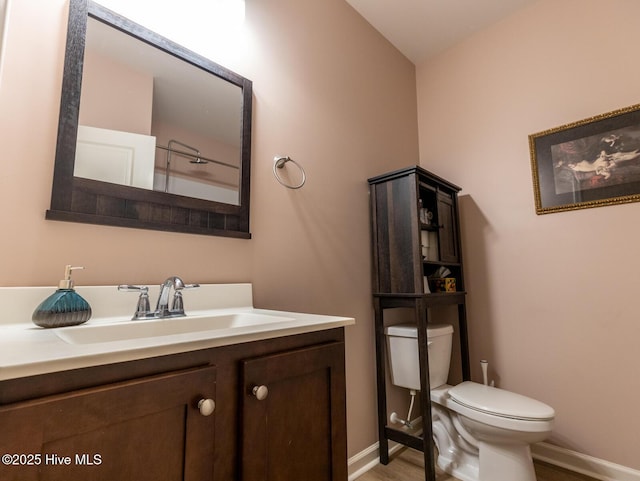 227 Cheswick Dr, Holly Ridge, NC 28445 - bathroom featuring toilet, vanity, wood finished floors, and baseboards