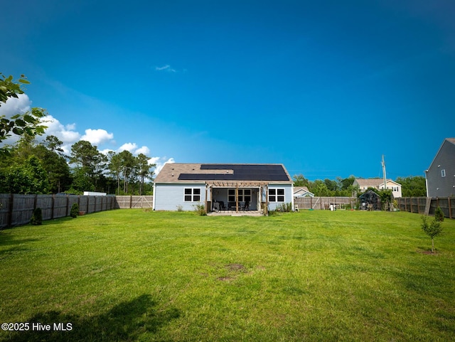 227 Cheswick Dr, Holly Ridge, NC 28445 - rear view of house with solar panels and a patio area