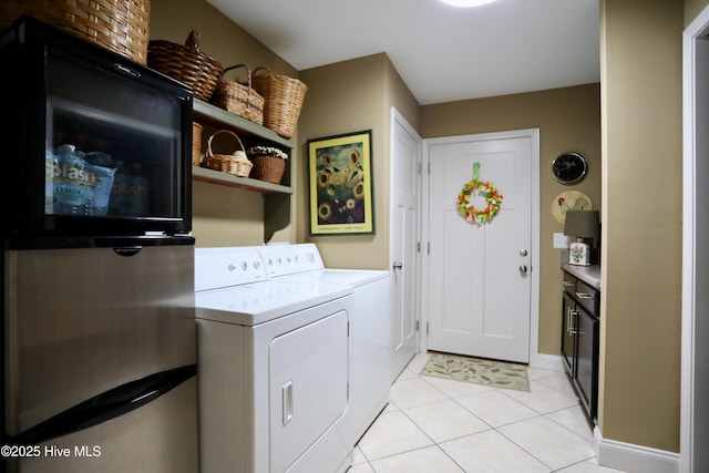 275 Pinehurst Trace Dr, Pinehurst, NC 28374 - laundry room featuring washing machine and clothes dryer, light tile patterned floors, and baseboards