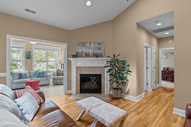 3101 Redfield Dr, Leland, NC 28451 - living room featuring light wood-style flooring, a tiled fireplace, baseboards, and recessed lighting
