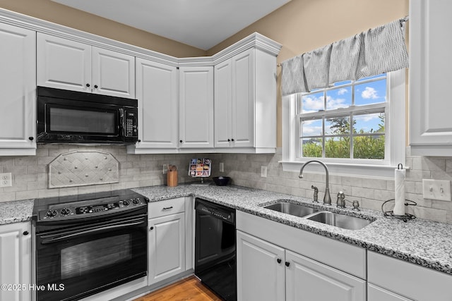 3101 Redfield Dr, Leland, NC 28451 - kitchen with black appliances, a sink, white cabinets, and tasteful backsplash