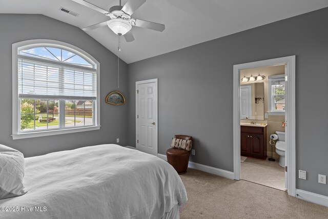 3101 Redfield Dr, Leland, NC 28451 - bedroom with vaulted ceiling, multiple windows, light colored carpet, baseboards, and a sink