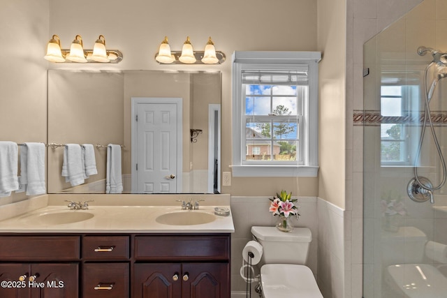 3101 Redfield Dr, Leland, NC 28451 - bathroom featuring toilet, plenty of natural light, double vanity, a shower stall, and tile walls