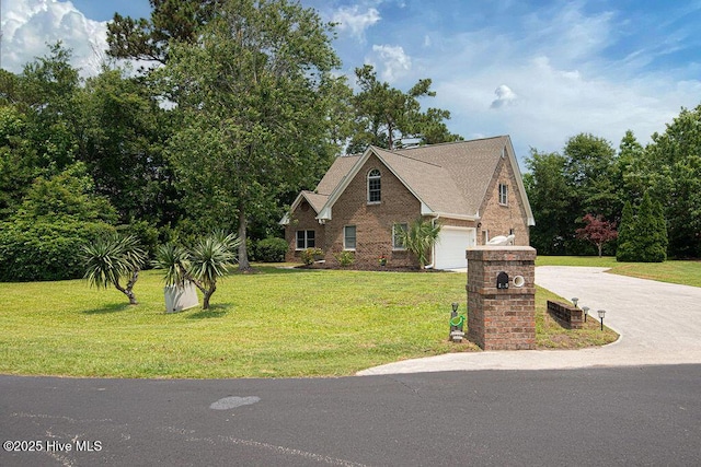 105 Sea Turtle Cv, Sneads Ferry, NC 28460 - view of front of property featuring driveway, a front yard, brick siding, and an attached garage