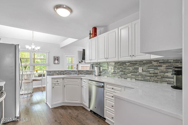 105 Sea Turtle Cv, Sneads Ferry, NC 28460 - kitchen with stainless steel appliances, a sink, white cabinetry, a chandelier, and decorative backsplash