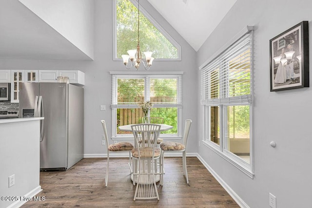 105 Sea Turtle Cv, Sneads Ferry, NC 28460 - dining room with a chandelier, healthy amount of natural light, wood finished floors, high vaulted ceiling, and baseboards