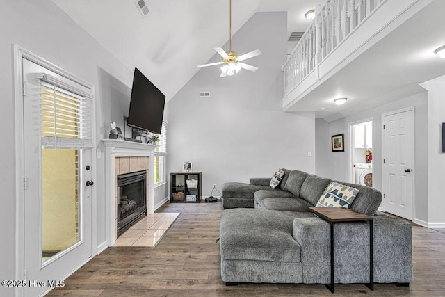 105 Sea Turtle Cv, Sneads Ferry, NC 28460 - living room featuring washer / dryer, a ceiling fan, a fireplace, wood finished floors, and high vaulted ceiling