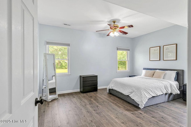 105 Sea Turtle Cv, Sneads Ferry, NC 28460 - bedroom featuring wood finished floors, multiple windows, baseboards, and a ceiling fan
