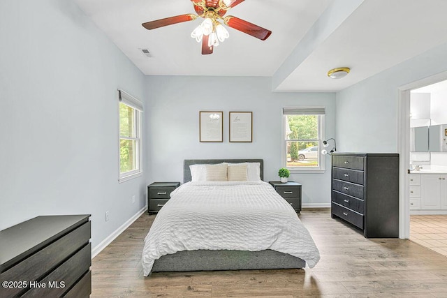 105 Sea Turtle Cv, Sneads Ferry, NC 28460 - bedroom with light wood finished floors, baseboards, ensuite bath, and ceiling fan