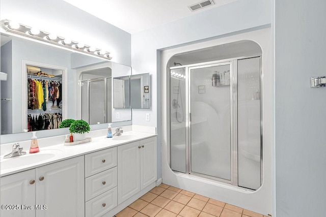 105 Sea Turtle Cv, Sneads Ferry, NC 28460 - full bath featuring a stall shower, double vanity, tile patterned floors, and a spacious closet