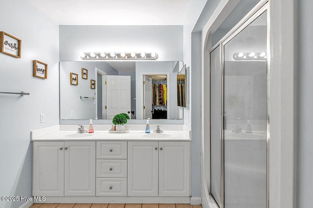 105 Sea Turtle Cv, Sneads Ferry, NC 28460 - bathroom with double vanity, a shower stall, a walk in closet, and tile patterned flooring