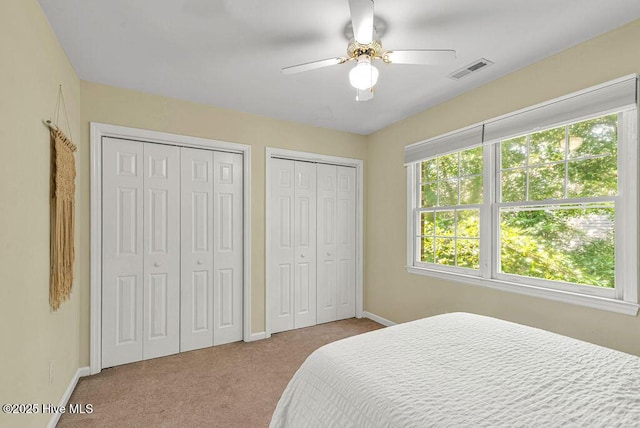 105 Sea Turtle Cv, Sneads Ferry, NC 28460 - carpeted bedroom featuring two closets, baseboards, and a ceiling fan
