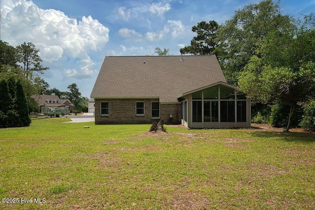 105 Sea Turtle Cv, Sneads Ferry, NC 28460 - rear view of property with a sunroom, a lawn, and brick siding