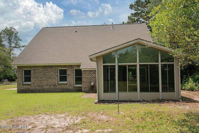 105 Sea Turtle Cv, Sneads Ferry, NC 28460 - back of property with a sunroom, brick siding, and a lawn