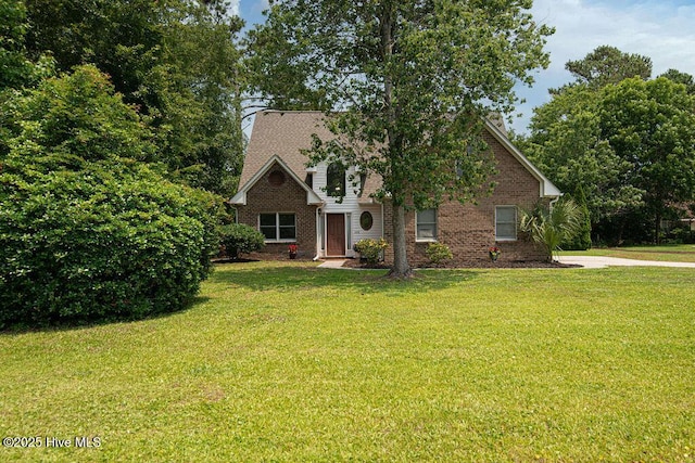 105 Sea Turtle Cv, Sneads Ferry, NC 28460 - view of front of property with a front yard, brick siding, and a chimney