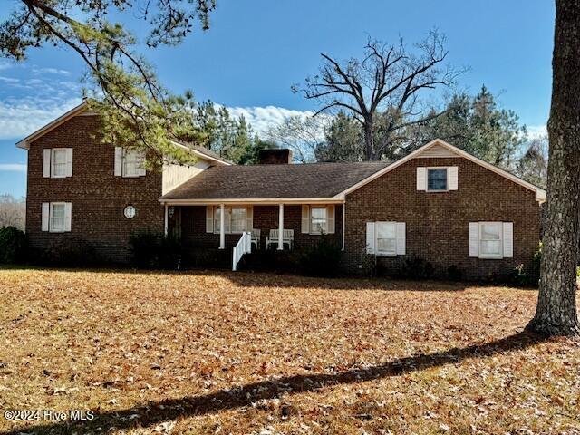 1164 Ocean Hwy N, Hertford, NC 27944 - view of front of house with a chimney, brick siding, and a porch