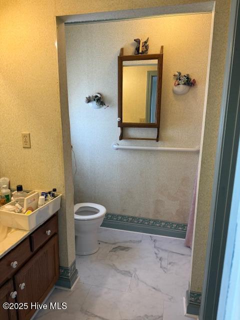 1164 Ocean Hwy N, Hertford, NC 27944 - bathroom with vanity, toilet, and marble look tile flooring