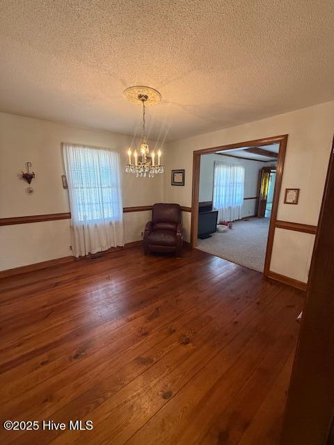 1164 Ocean Hwy N, Hertford, NC 27944 - dining area with a chandelier, a textured ceiling, and wood finished floors
