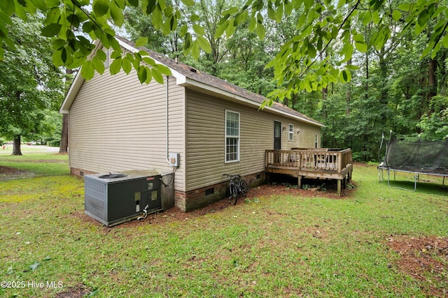 330 Brookfield Dr, Wilmington, NC 28405 - back of property featuring a trampoline, crawl space, a deck, and a lawn