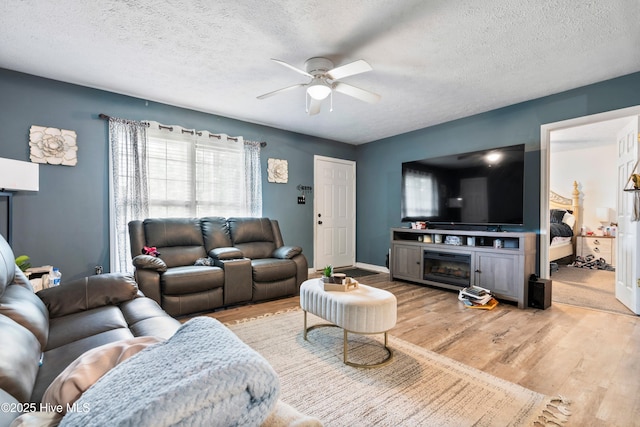 330 Brookfield Dr, Wilmington, NC 28405 - living area with ceiling fan, wood finished floors, a textured ceiling, and a fireplace