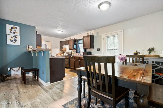 330 Brookfield Dr, Wilmington, NC 28405 - dining room with a textured ceiling and light wood-type flooring