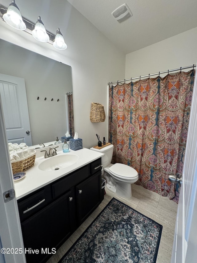 134 Longhorn Rd, Jacksonville, NC 28546 - full bathroom featuring vanity, toilet, tile patterned flooring, and a shower with curtain