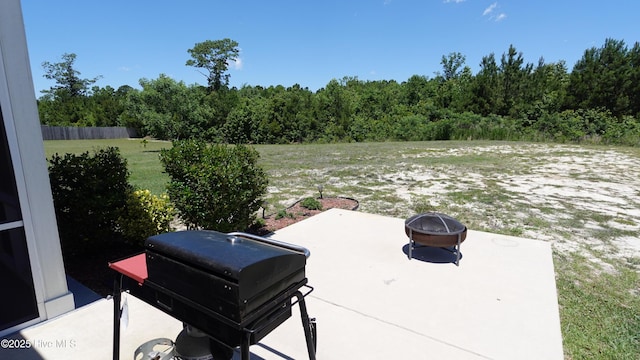 134 Longhorn Rd, Jacksonville, NC 28546 - view of patio with a fire pit, a grill, and a forest view