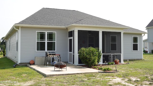 134 Longhorn Rd, Jacksonville, NC 28546 - rear view of house featuring a patio, a shingled roof, a yard, and a fire pit