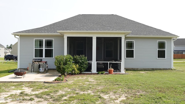 134 Longhorn Rd, Jacksonville, NC 28546 - rear view of house with an outdoor fire pit, a patio, roof with shingles, and a sunroom
