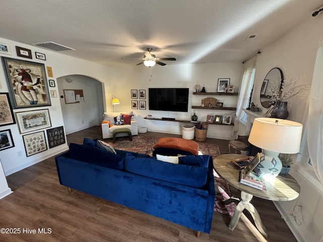 134 Longhorn Rd, Jacksonville, NC 28546 - living area with ceiling fan, arched walkways, wood finished floors, a textured ceiling, and baseboards