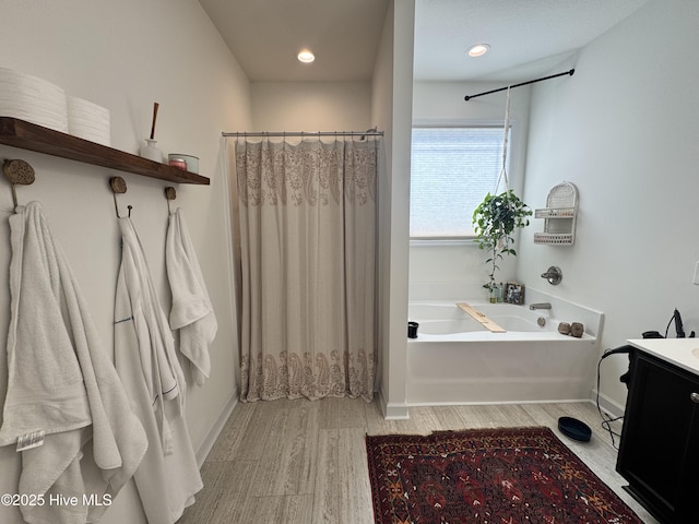 134 Longhorn Rd, Jacksonville, NC 28546 - bathroom featuring a garden tub, vanity, wood finished floors, baseboards, and recessed lighting