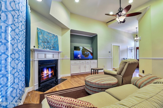 1711 Heather Run Ct SE, Bolivia, NC 28422 - living area featuring light wood-style floors, a fireplace with flush hearth, ceiling fan, recessed lighting, and baseboards